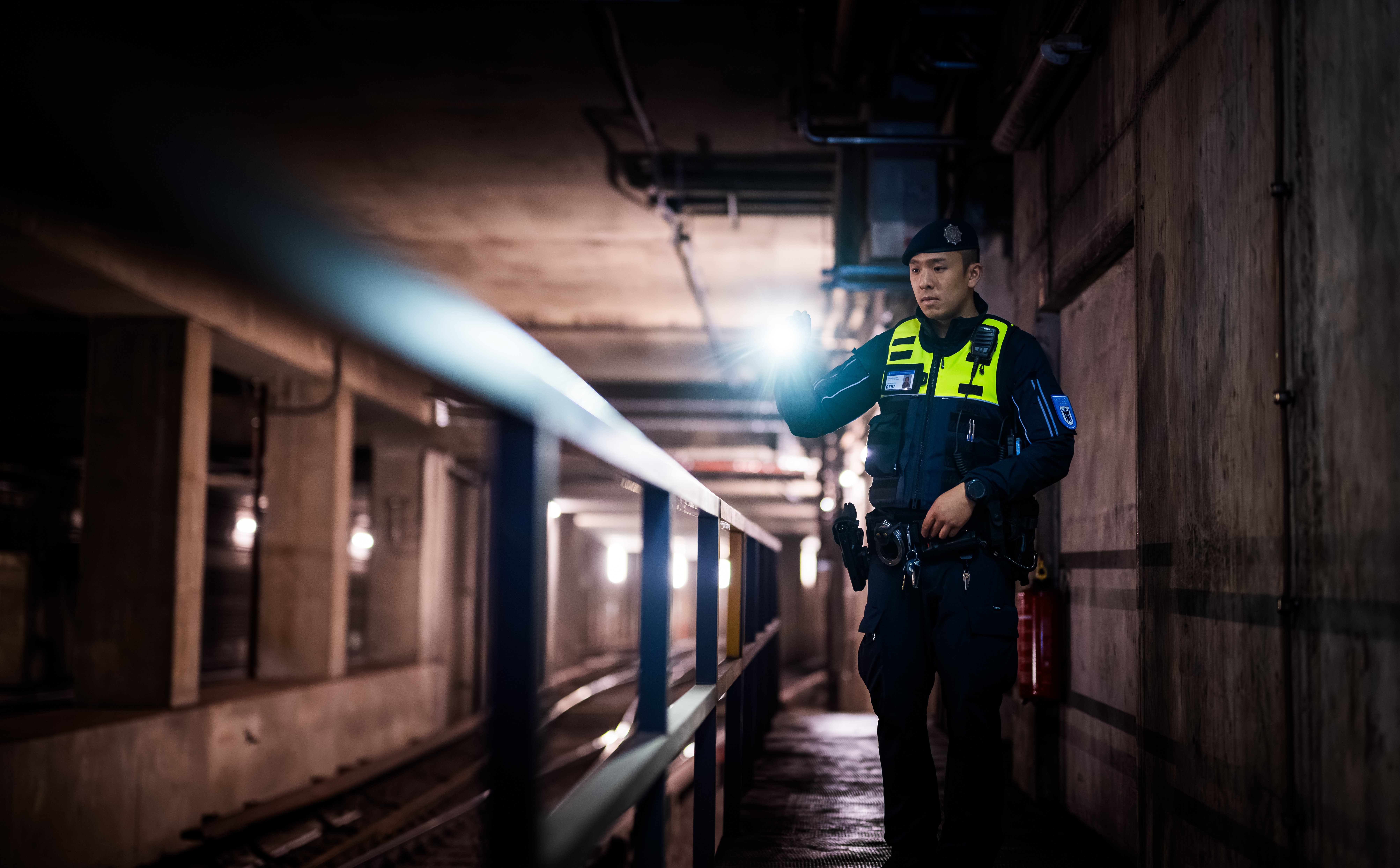 A Münchner U-Bahnwache guard patrolling a tunnel.